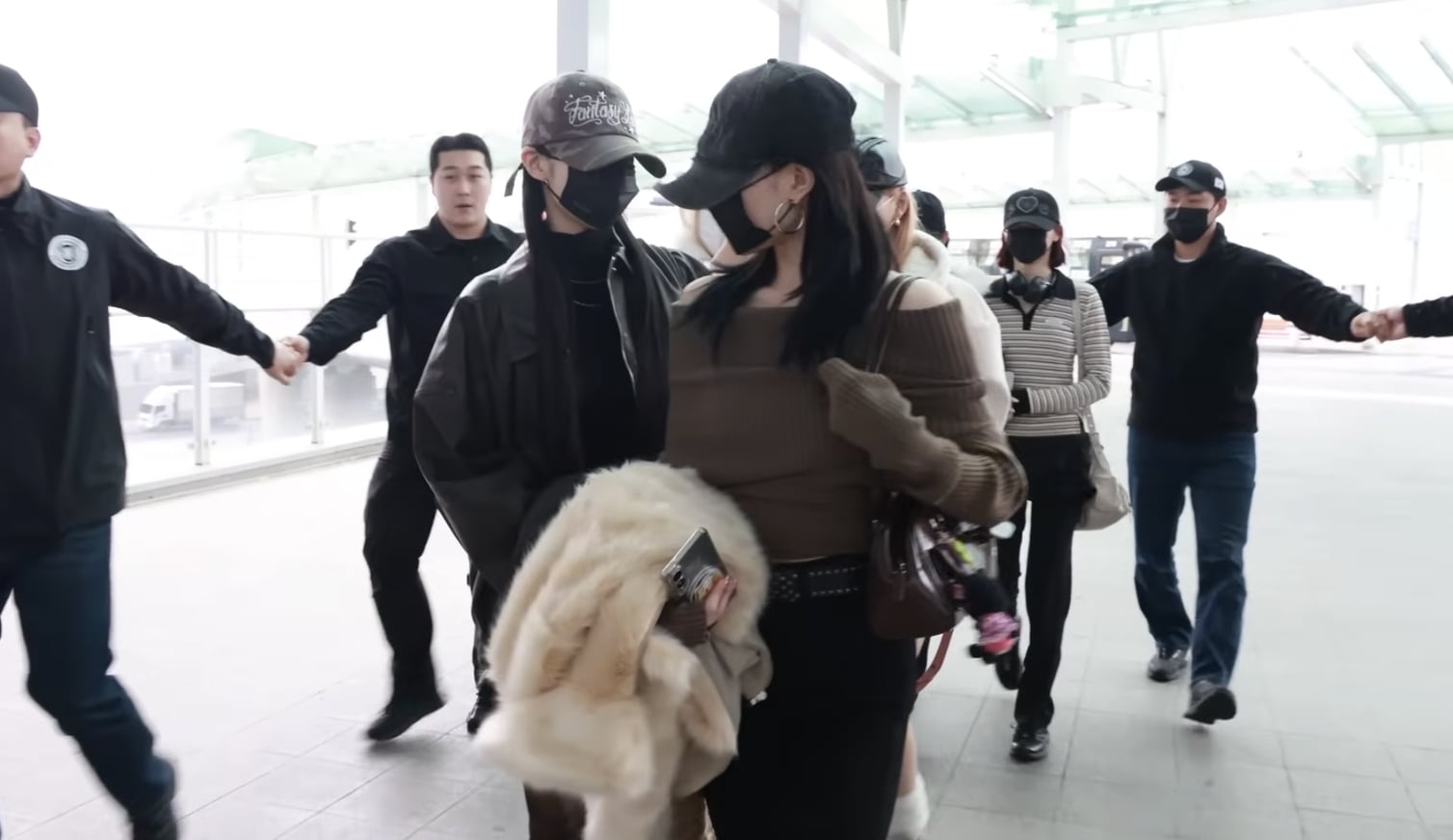 Hearts2Hearts 保全手拉手護送畫面引熱議!網友直呼像在跳民俗舞,藝人機場擾民爭議再起!