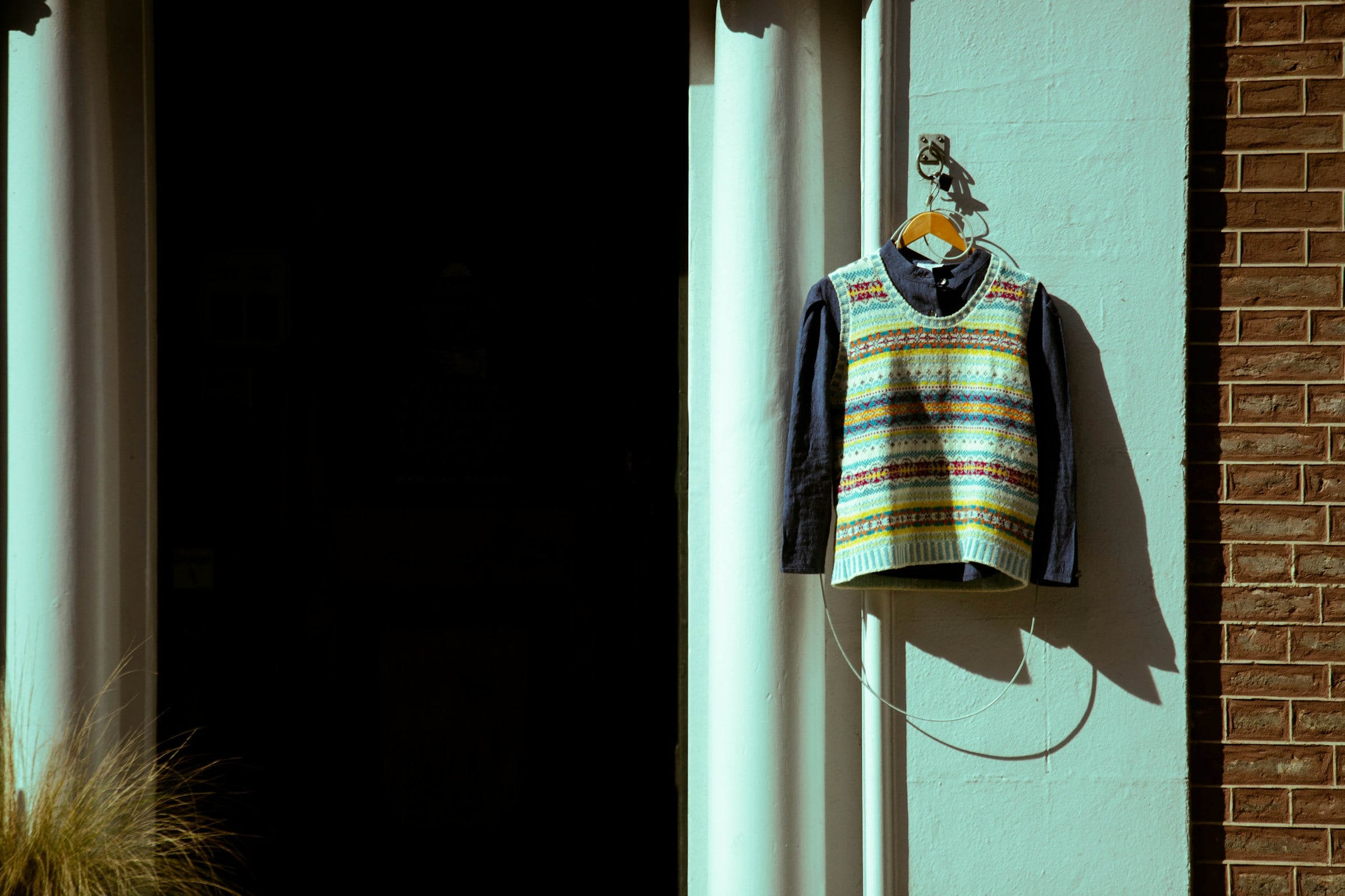 shirt and fair isle sweater on a hanger
